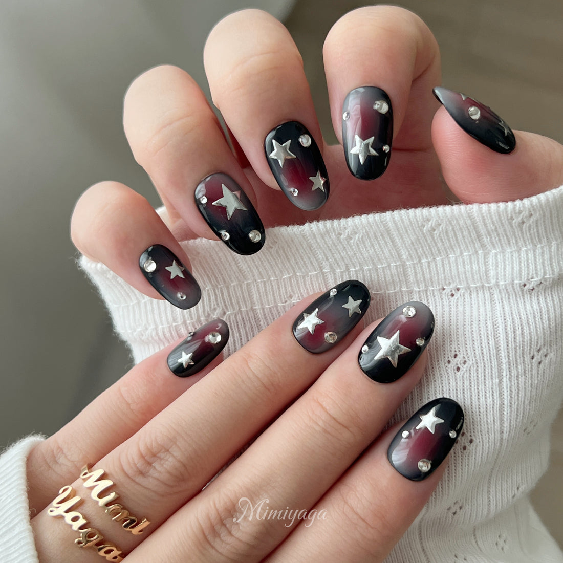 Rebel Radio press on nails with black base, red and smoky grey airbrush, silver stars and crystal accents