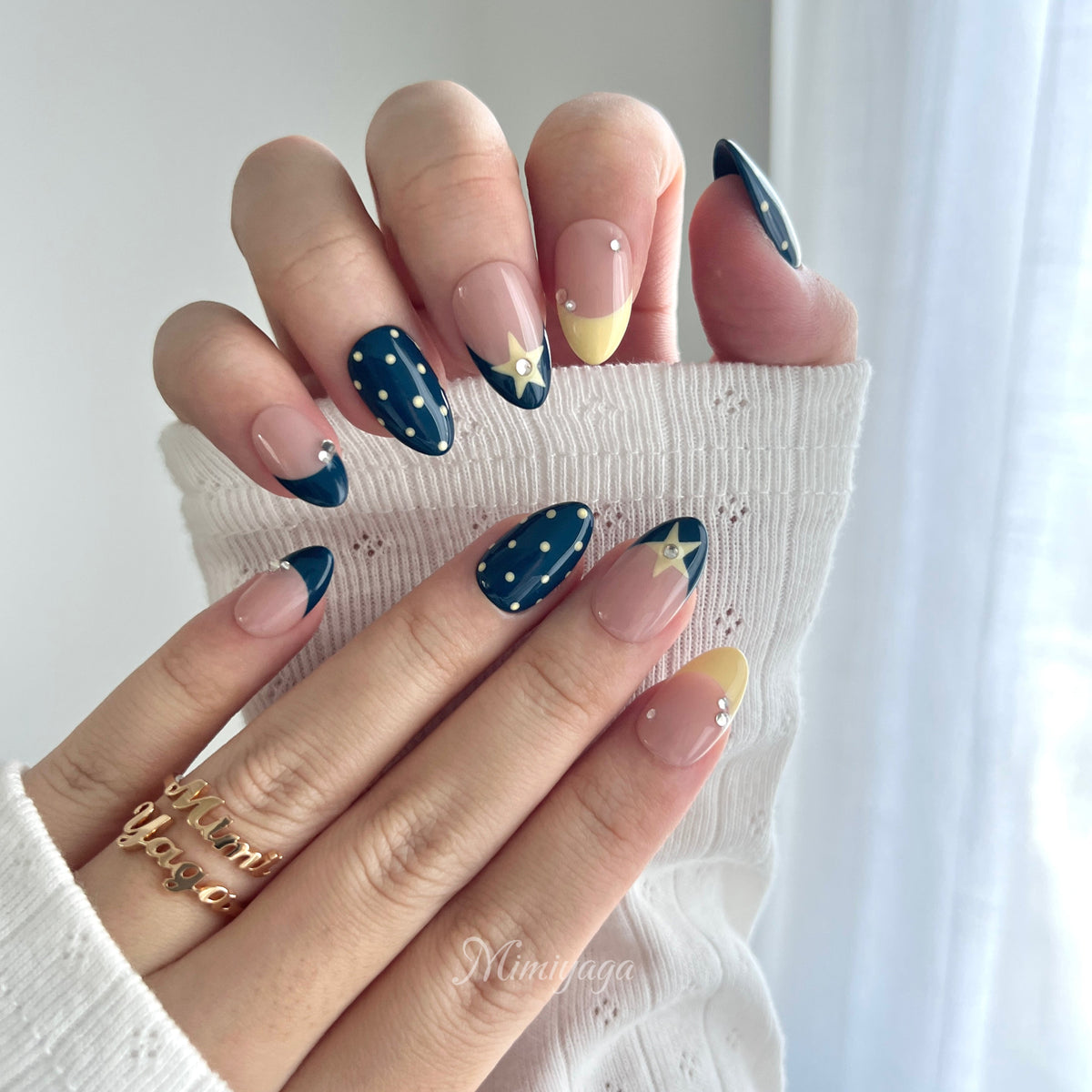 Close-up of Blue Hour Social handmade press on nails showing star, polka dot, French tip and crystal details
