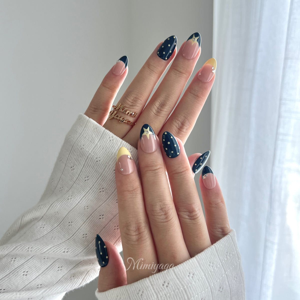Blue Hour Social navy blue, blush and butter yellow press on nails worn on hands