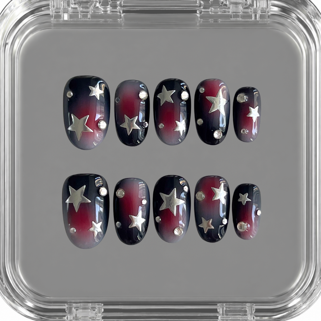 Rebel Radio press on nails with black base, red and smoky grey airbrush, silver stars and crystal accents